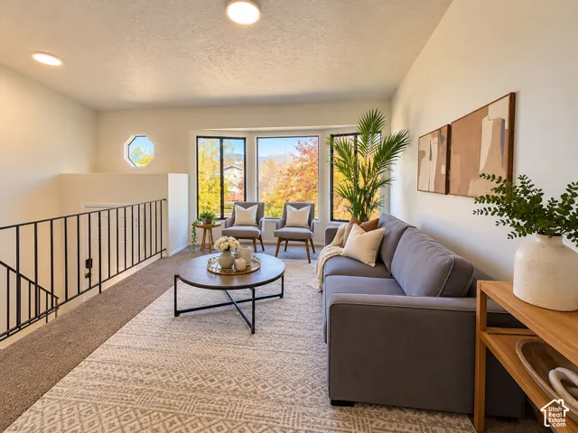 Recessed lighting illuminating a spacious room with a multi-pane bay window