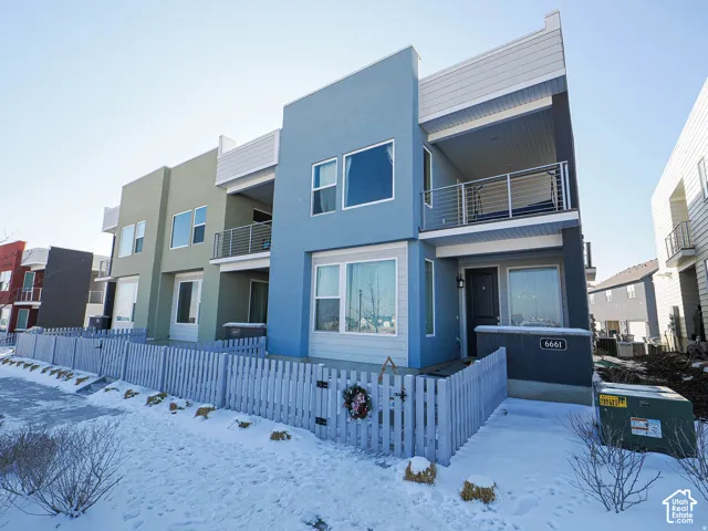 Contemporary exterior with a balcony featuring metal railings
