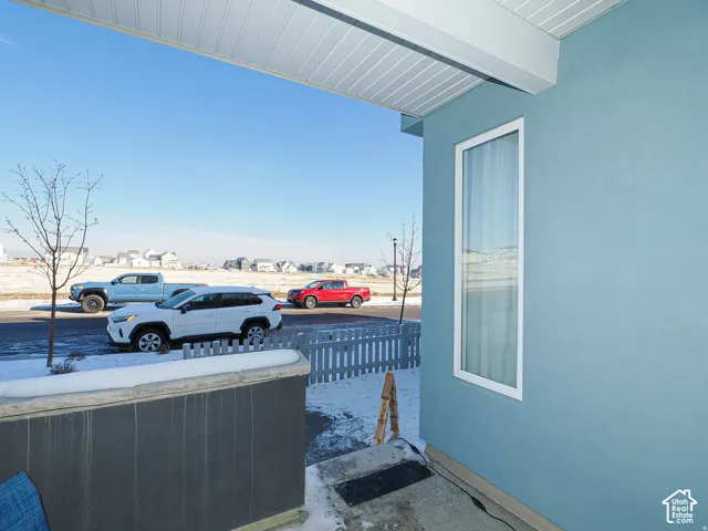 Smooth stucco exterior with a tall vertical window featuring white trim