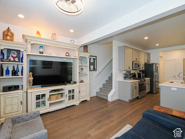 Open-concept living space featuring wood-finish flooring, recessed lighting, and a modern ceiling fan