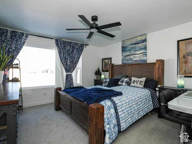 Recessed window with white trim, a matte black ceiling fan, white walls, and light-toned carpeting