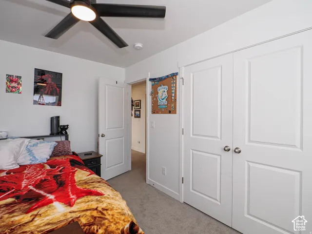 Recessed panel doors, ceiling fan with integrated lighting, and carpeted flooring