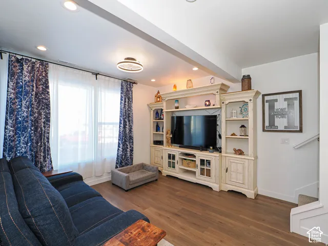 Recessed lighting, wood-finish flooring, and a decorative ceiling fixture