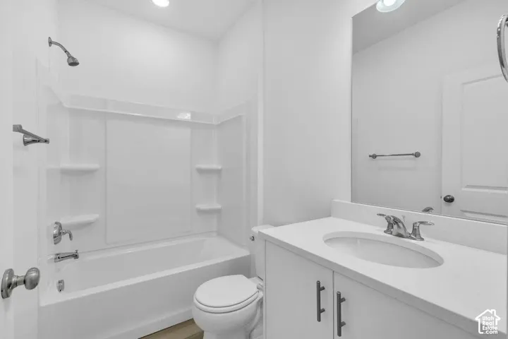 White vanity with a light-toned countertop and an undermount sink