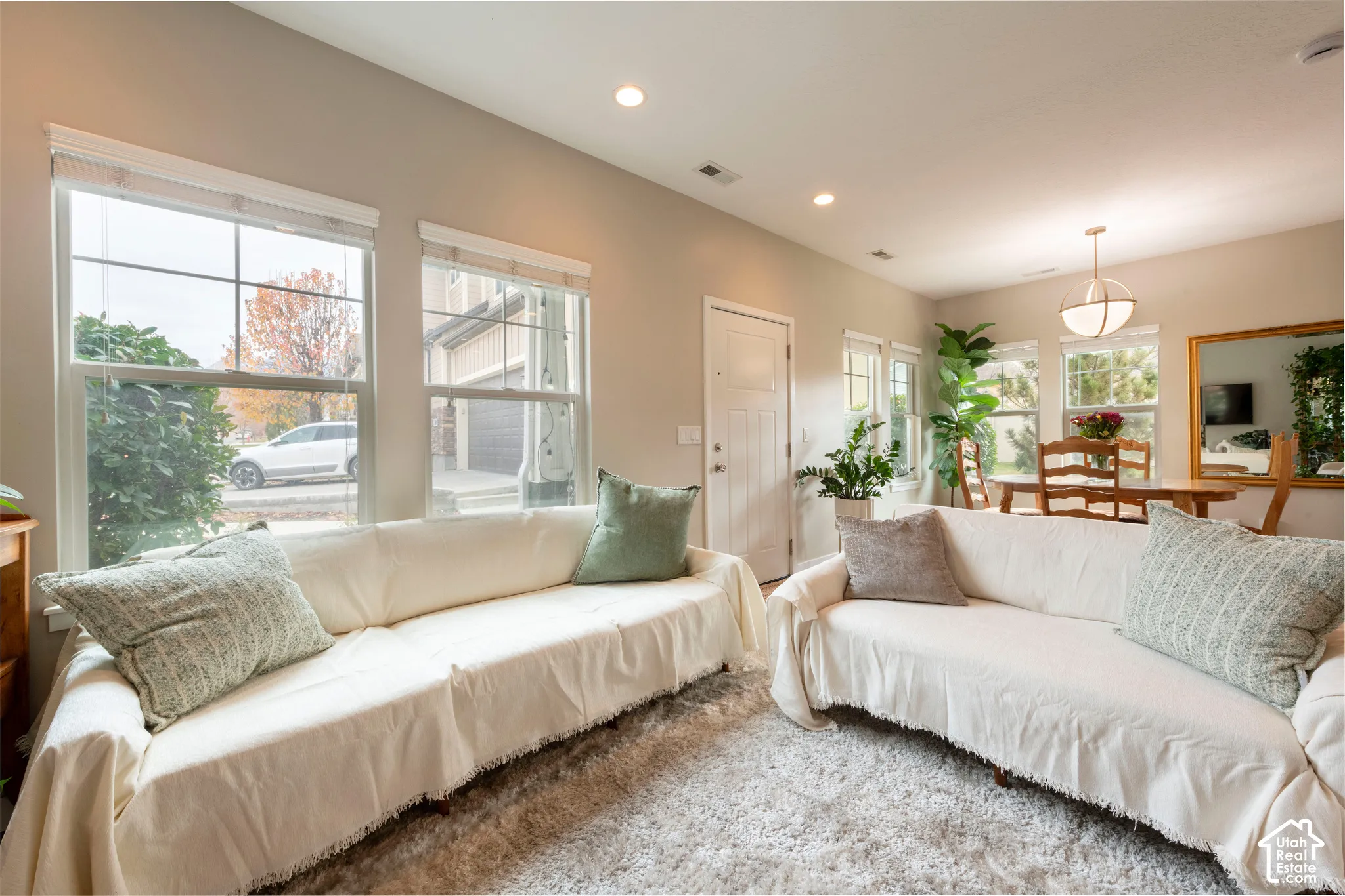 Recessed lighting, multiple windows, and a front entry door with transom window