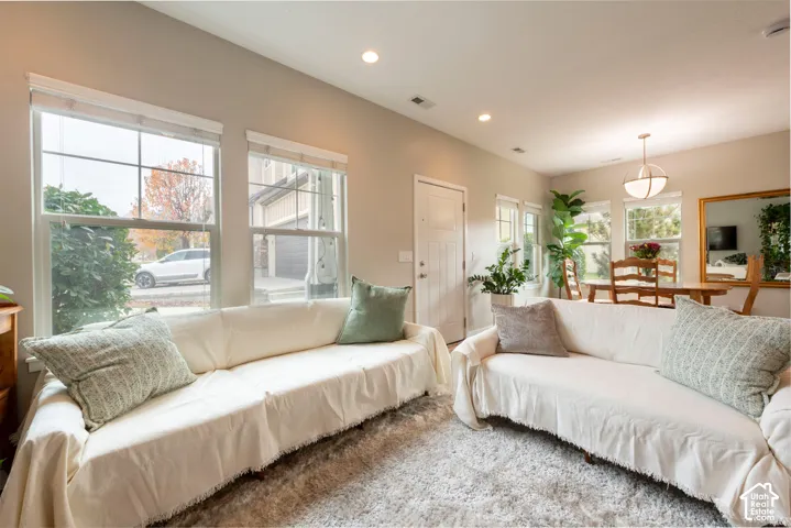 Recessed lighting, multiple windows, and a front entry door with transom window
