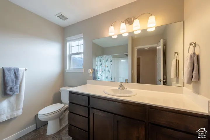 Dark wood-finish vanity with a white countertop and integrated sink