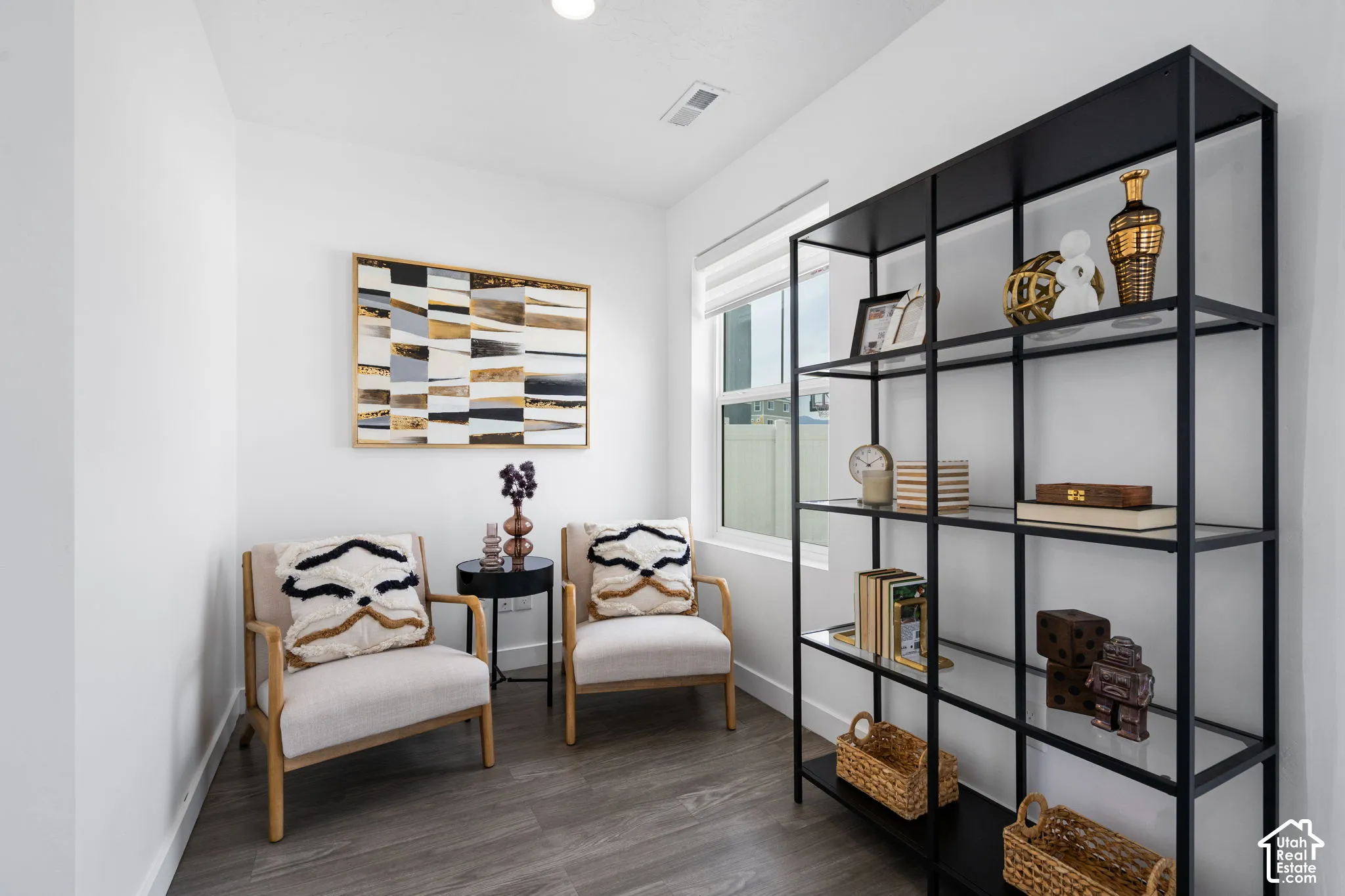 Neutral wall colors, wood-finish flooring, recessed lighting, and a large window with roller shades
