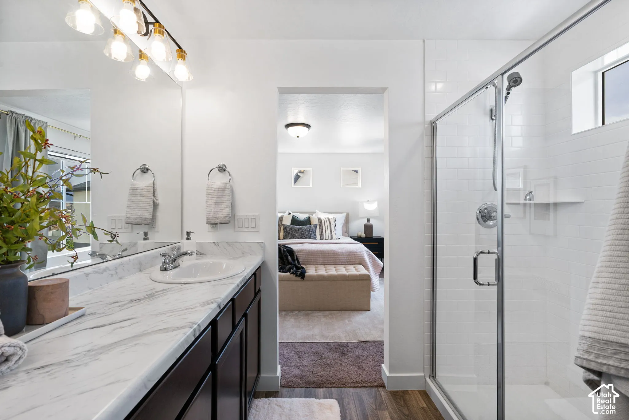 Vanity with a white, marble-patterned countertop and undermount sink