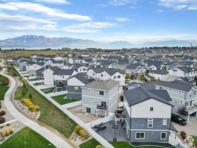 Mountain backdrop, residential area, two-tone exterior, multi-story construction, private balcony