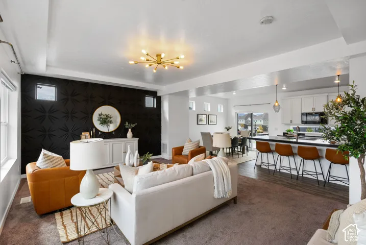 Open-concept living space featuring a textured accent wall, recessed lighting, and wood-finish flooring