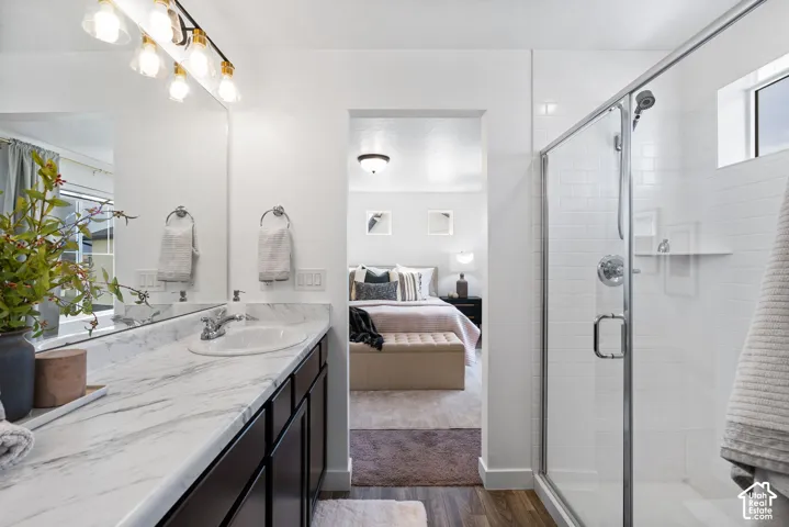 Vanity with a white, marble-patterned countertop and undermount sink