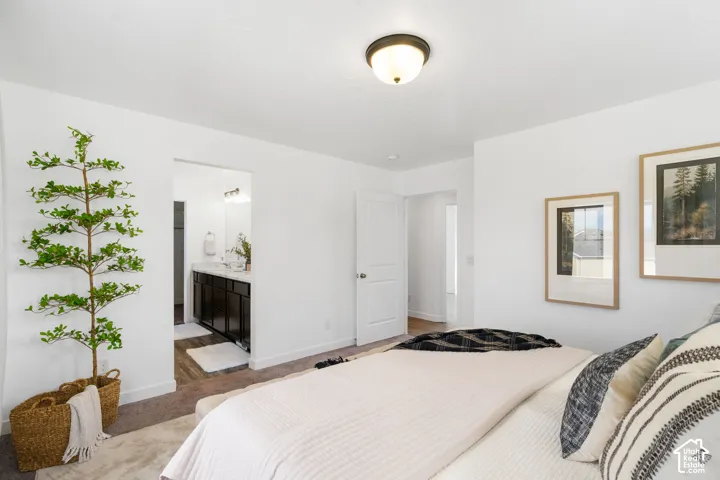 Neutral wall color, carpeted flooring, overhead flush mount light fixture, and a white door with a silver-tone handle