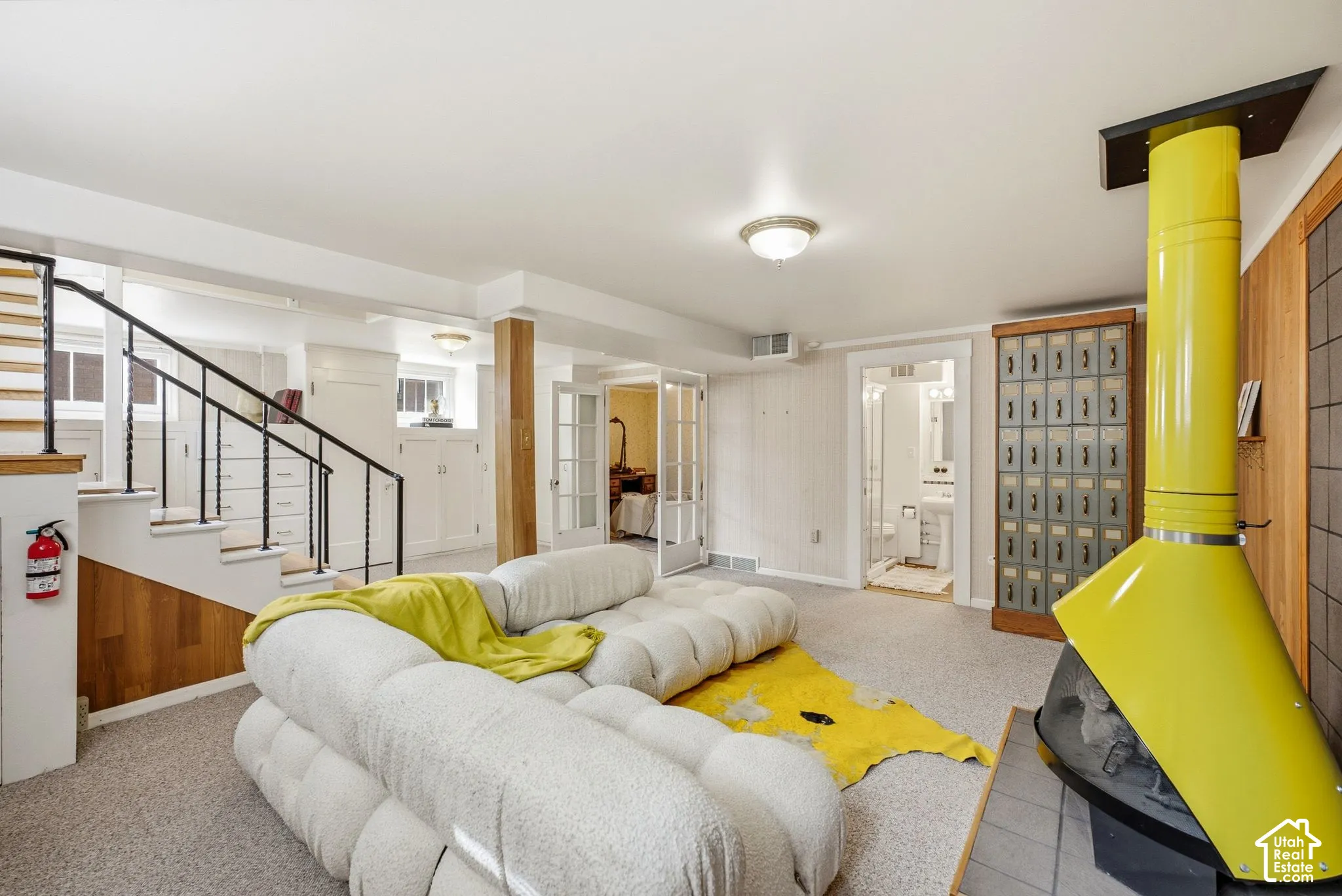Carpeted floor with a unique freestanding yellow fireplace