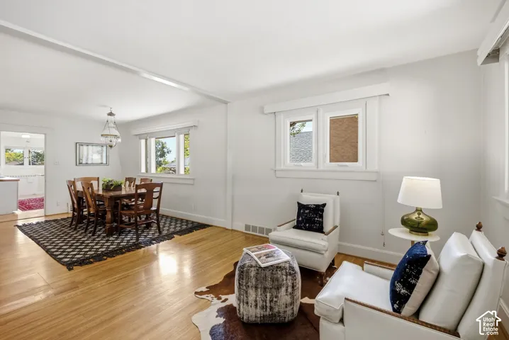 Hardwood flooring throughout, white painted trim work, multiple windows, and a built-in ceiling light fixture