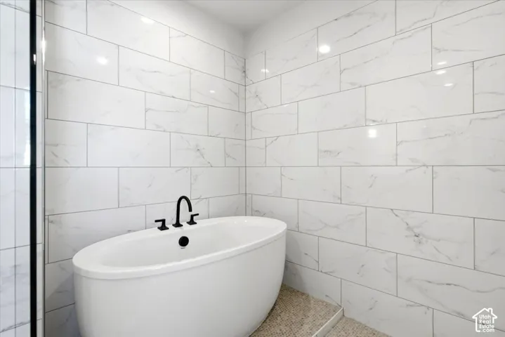 Freestanding soaking tub with matte black fixtures