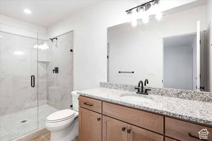 Walk-in shower with clear glass enclosure and tile surround