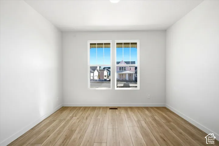 Recessed ceiling lighting, wood-finish flooring, white walls, and dual pane windows