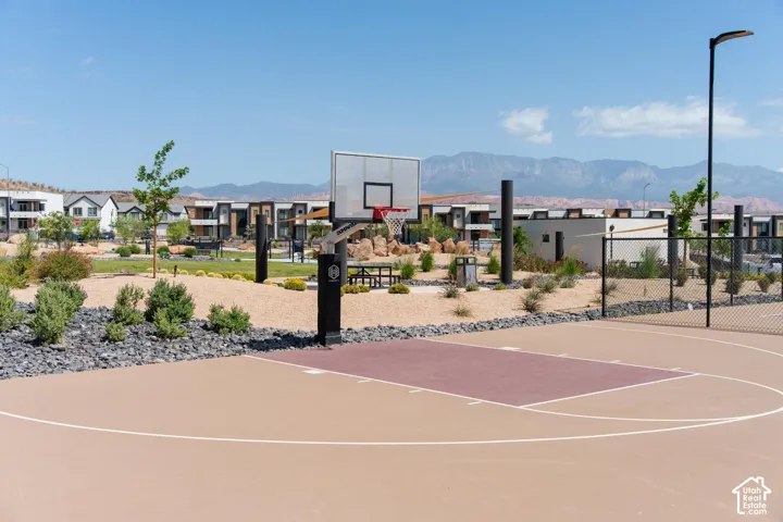 Outdoor basketball court with a painted playing surface and adjustable hoop