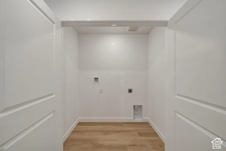 Recessed utility area with wood-finish flooring