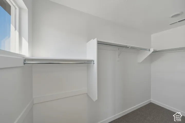 Built-in shelving and hanging rods, recessed ceiling light, and window