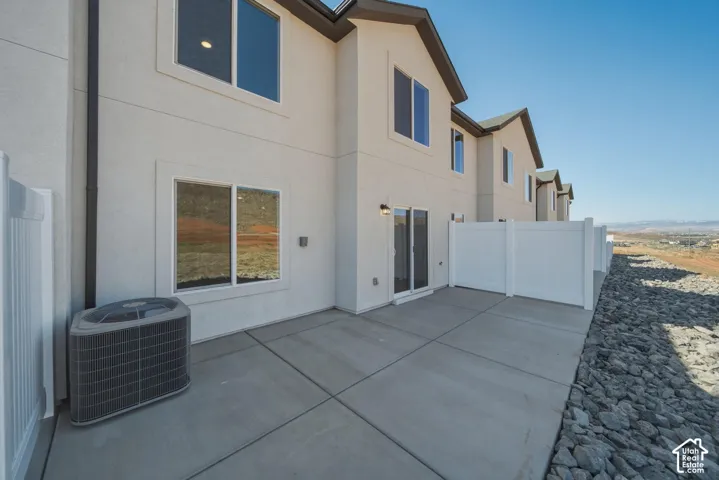 Private patio featuring concrete surfacing and white vinyl fencing