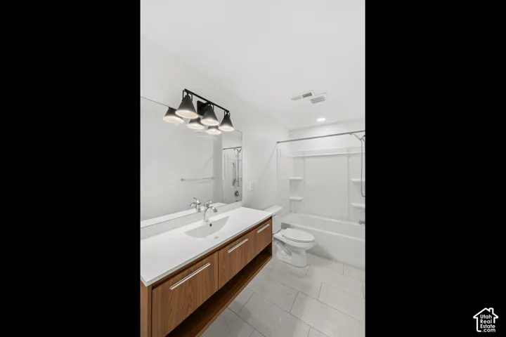 Modern vanity with wood-finish cabinetry, white countertop, and integrated sink