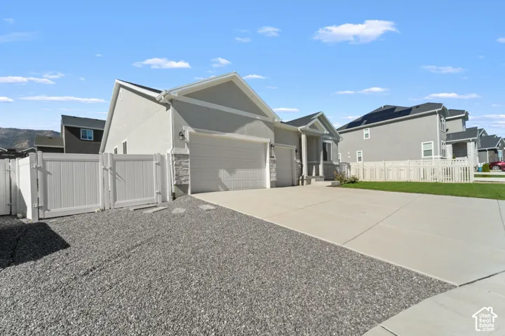 Light gray exterior with stone accents and a two-car garage