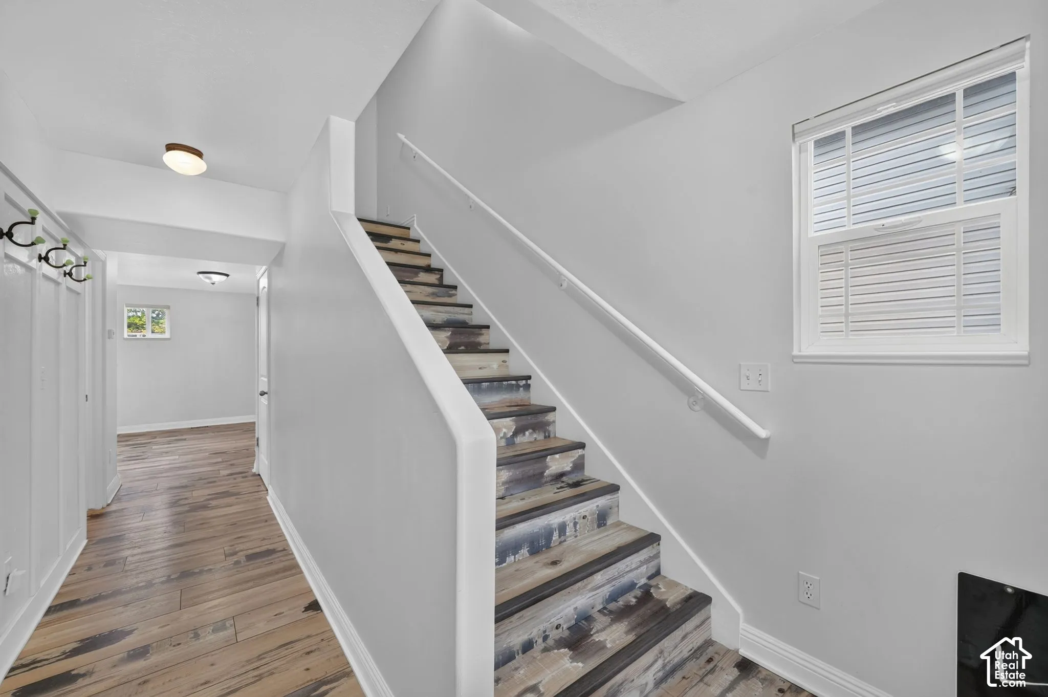 Staircase with unique distressed wood-finish treads and white risers