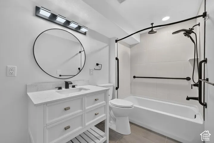 Vanity with a solid surface countertop, undermount sink, and matte black fixtures