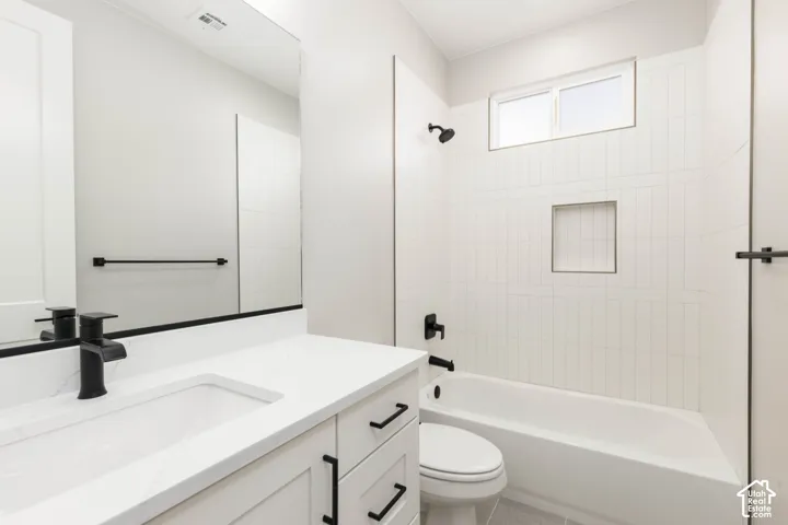 White single vanity with an integrated rectangular sink, quartz countertop, and matte black faucet