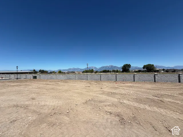 Expansive dirt lot with a prominent retaining wall