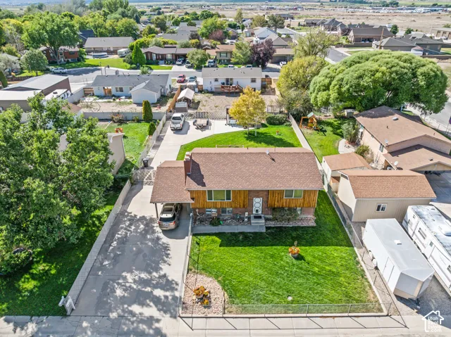 Property features an established lawn, mature trees, and a concrete driveway