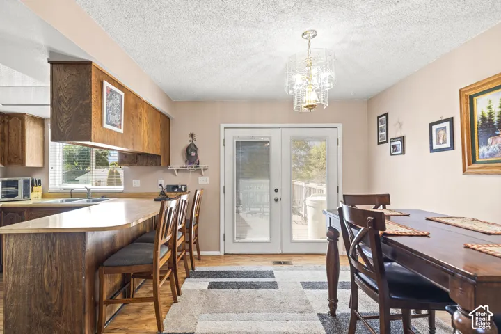 Kitchen featuring wood-finish cabinetry, a breakfast bar, and light-toned countertops