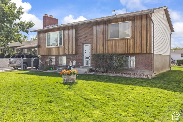 Brick and wood-paneled exterior with white siding accents
