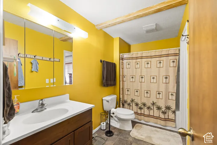 Vanity with a single basin, wood-finish cabinetry, and a wall-mounted medicine cabinet
