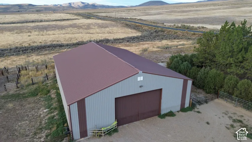 Metal-clad barn with a brown roof and brown garage-style door
