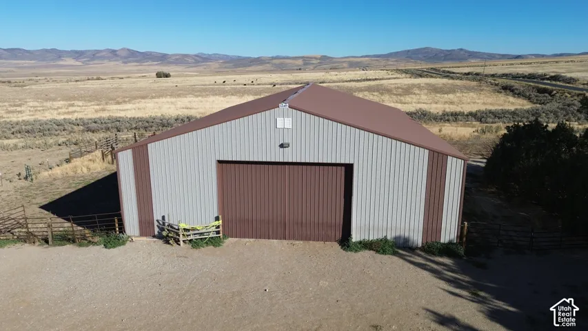 Steel-sided barn with a brown metal roof and a large brown roll-up door