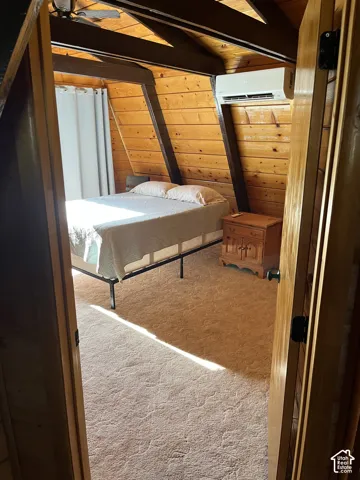 Angled wood-paneled walls with exposed beams