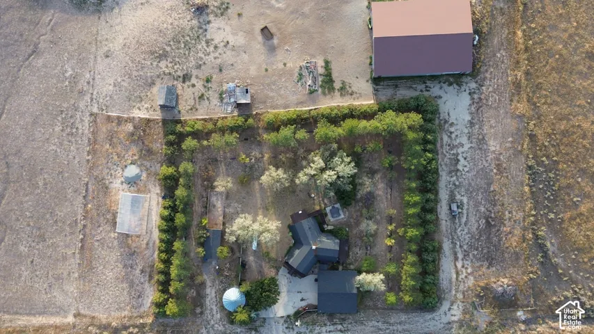 Expansive property featuring a multi-structure residence, separate utility building, and extensive surrounding land