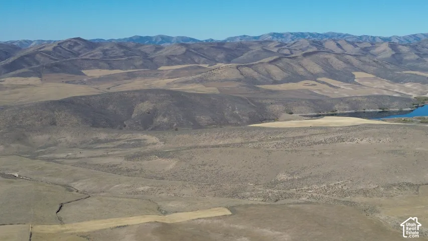 Expansive natural landscape with rolling hills and distant mountains
