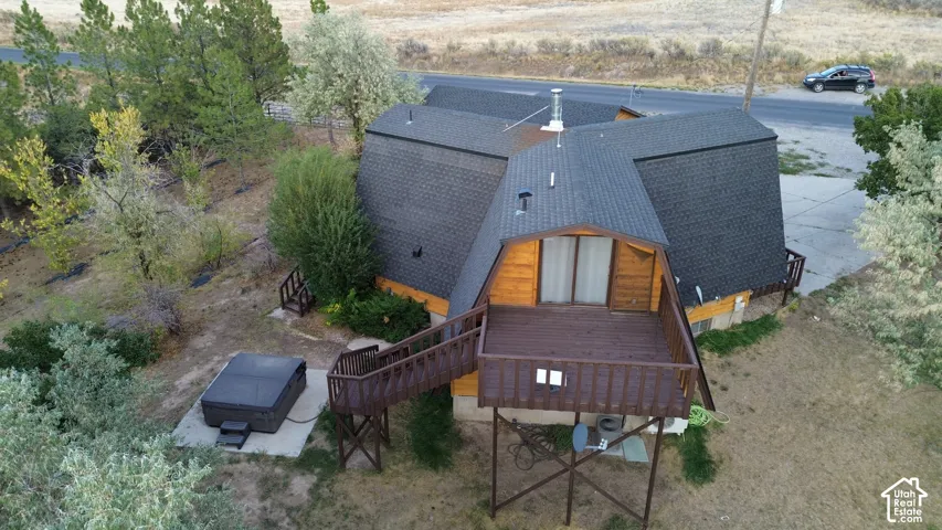 Distinctive A-frame architectural design featuring a dark composite roof, wood-finish exterior cladding, and expansive glazing