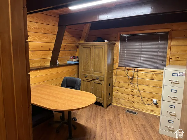 Wood-paneled room with wood-finish flooring