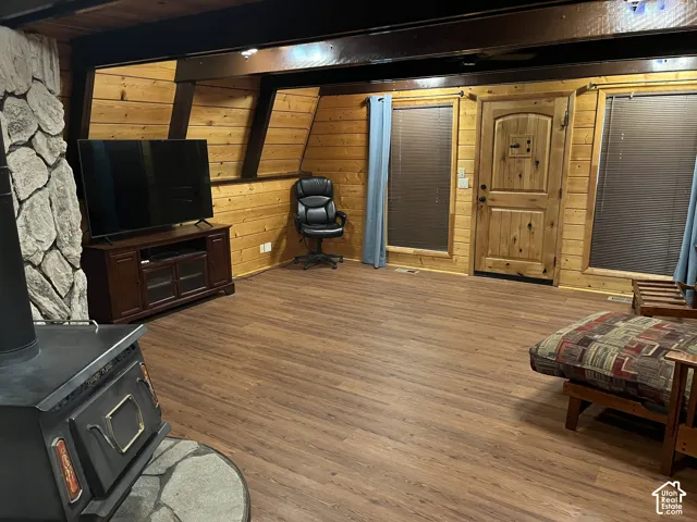 Wood-finish flooring throughout, complemented by wood plank walls and a natural wood door
