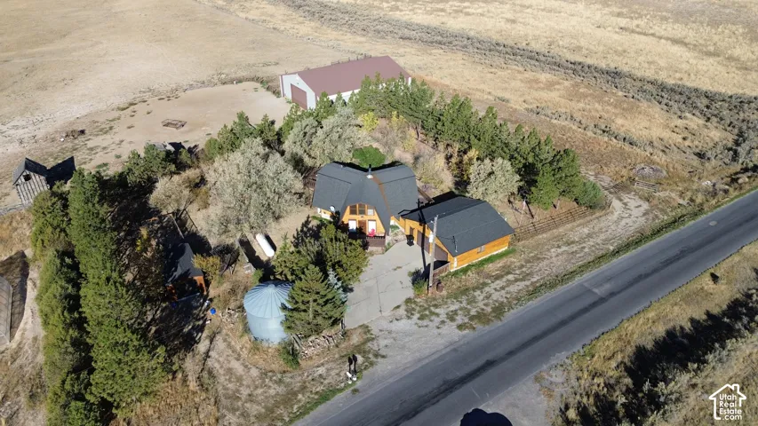 Domed primary residence with an attached structure, a detached outbuilding, a separate barn, and a large silo
