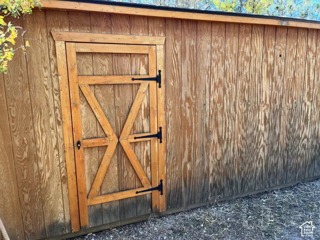 Wood-finish exterior wall with a barn-style door featuring black hardware