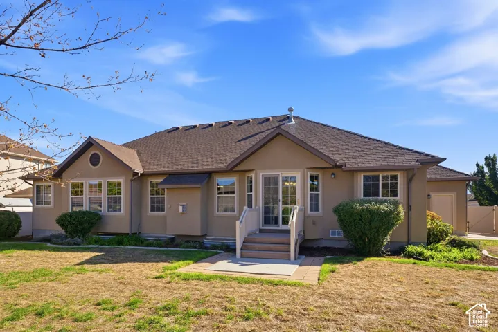 Stucco exterior with a shingle roof