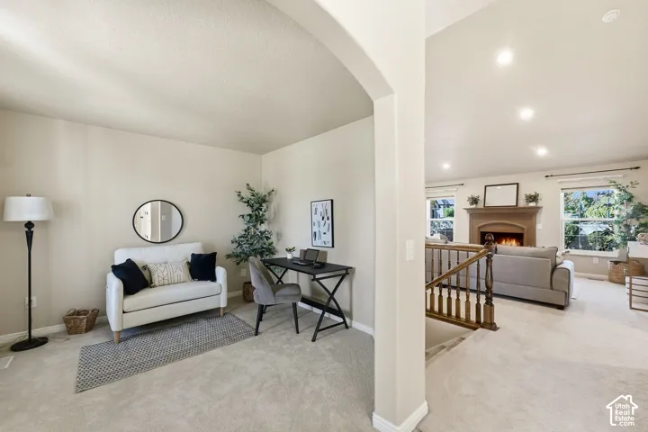 Arched entryway leading to a carpeted room
