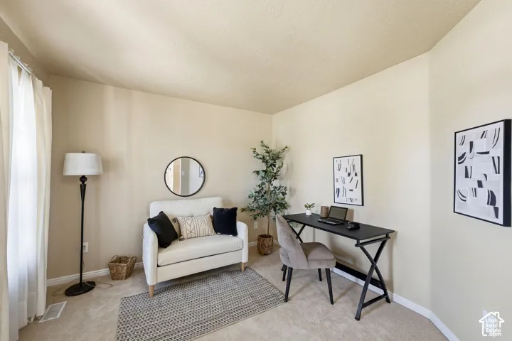 Neutral wall tones and wall-to-wall carpeting create a versatile interior