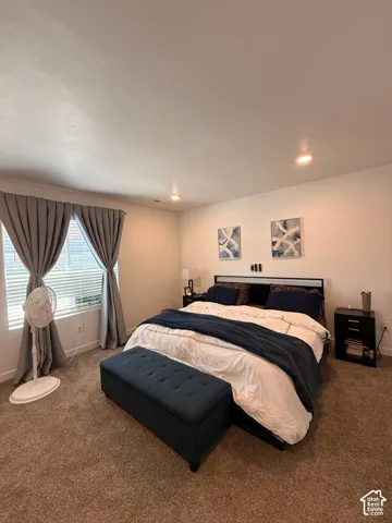 Recessed ceiling lighting, window blinds, and neutral wall tones